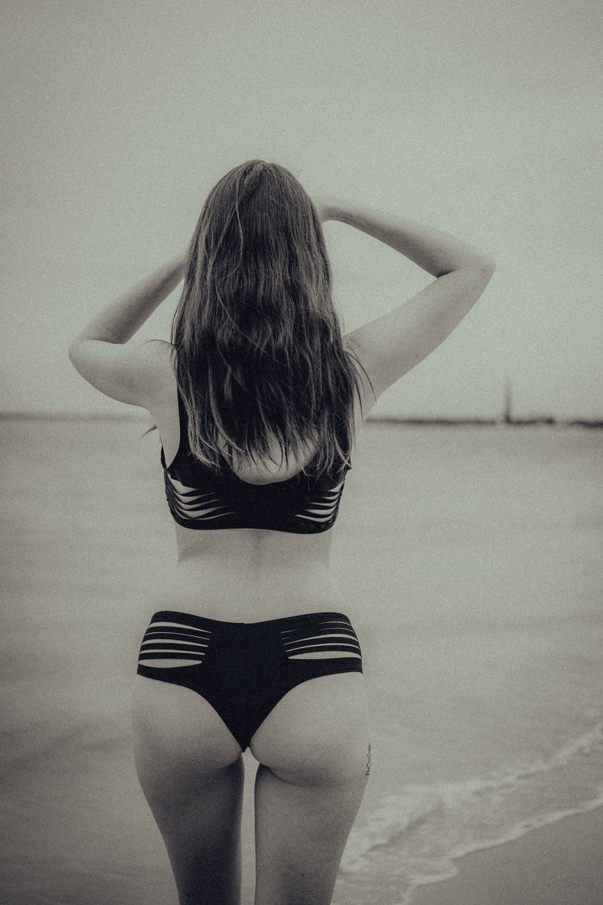Woman in a bikini by the water